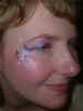 Face Painting: Adult female with subtle glittery pink and black eye makeup highlighted with white stars.